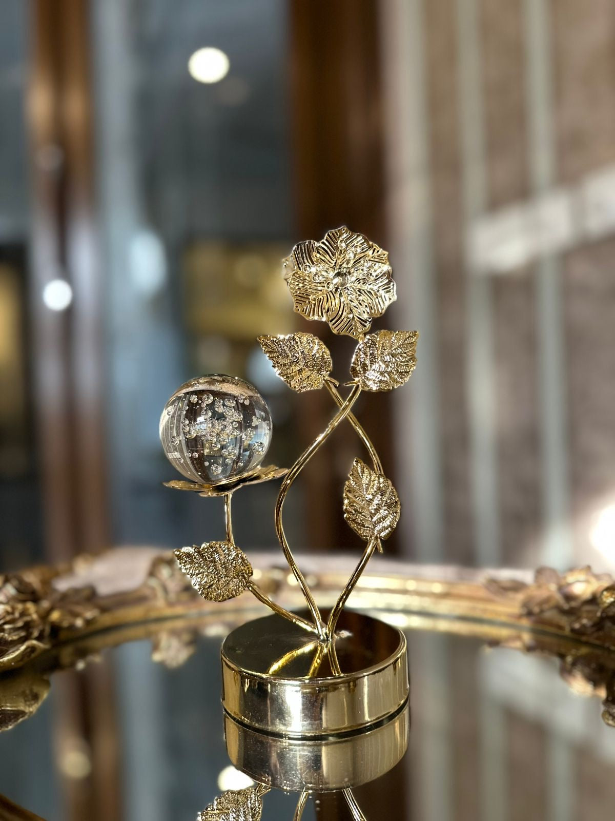 Golden metal leaf sculpture tabletop ornament features a crystal ball.